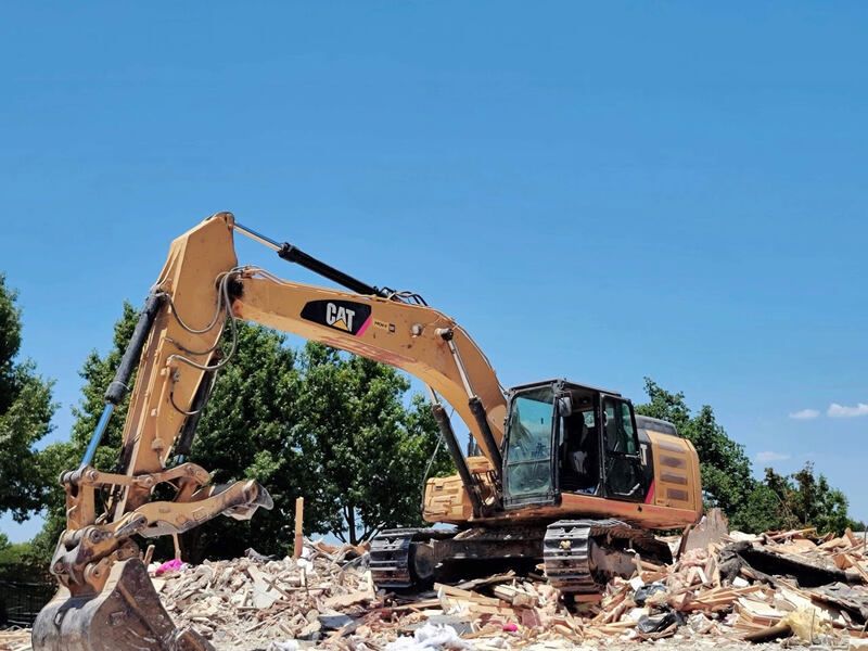 Division 31 excavator performing concrete and structural demolition